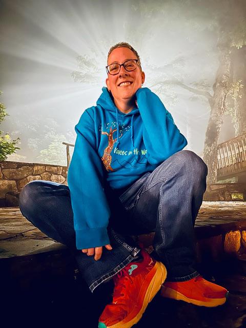 Amber Ferenz wearing sneakers sun behind her head